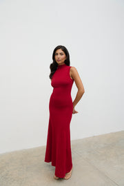 Woman wearing a red dress against a white background