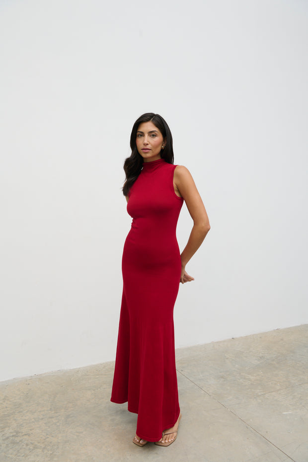 Woman wearing a red dress against a white background