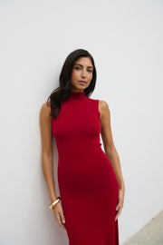 Woman wearing a red dress against a white background