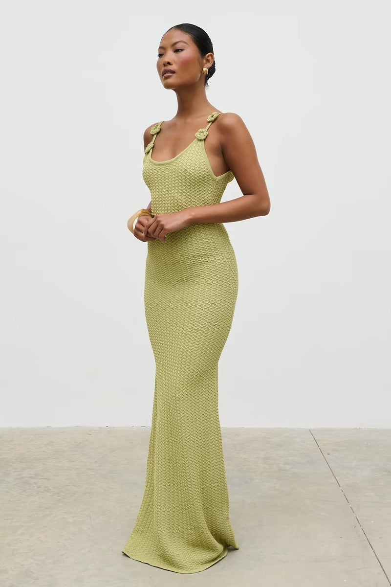 Woman wearing a green evening gown against a white background