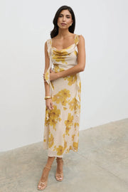 Woman wearing a floral dress with a plain background